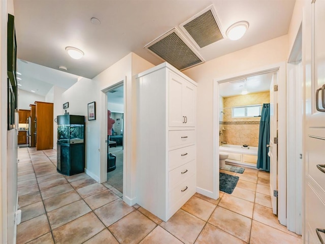 corridor with light tile patterned flooring