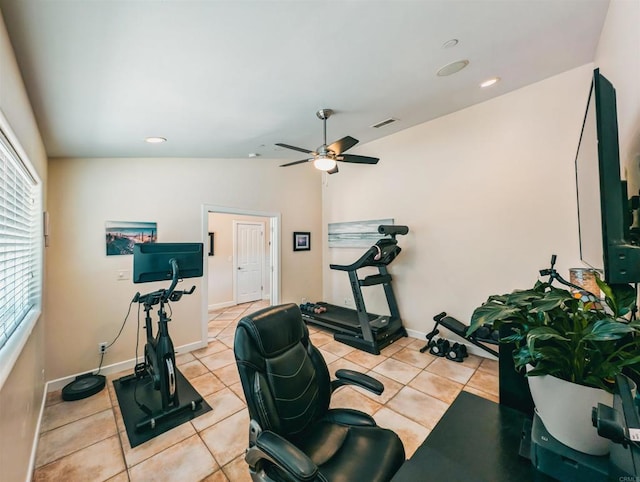 exercise room with lofted ceiling, light tile patterned floors, and ceiling fan