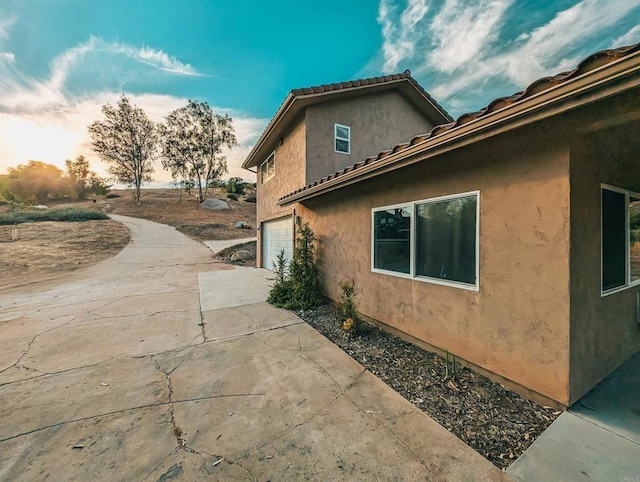 property exterior at dusk with a garage