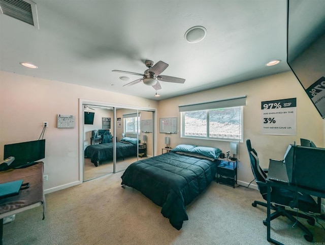 bedroom with light carpet, a closet, and ceiling fan