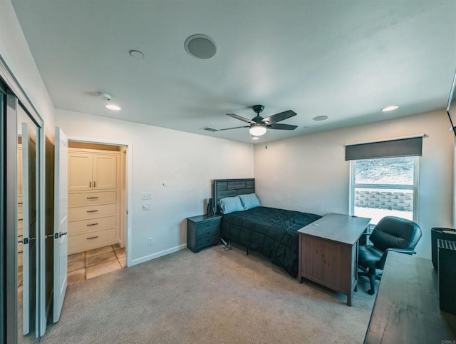 bedroom with ceiling fan and light colored carpet