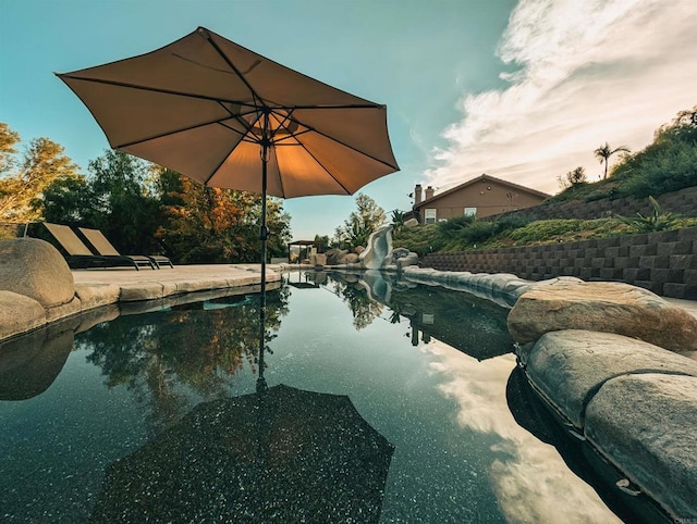 view of swimming pool featuring a patio and a water slide