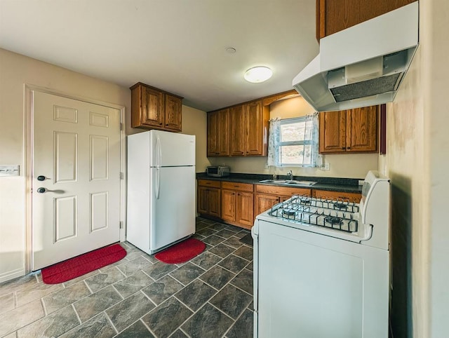 kitchen with sink, exhaust hood, and white appliances