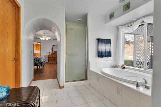 bathroom featuring a garden tub, connected bathroom, a ceiling fan, tile patterned floors, and a stall shower