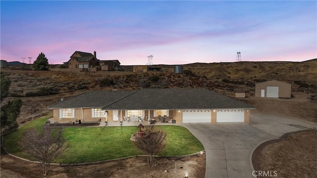 single story home with driveway, a front lawn, a tiled roof, and stucco siding