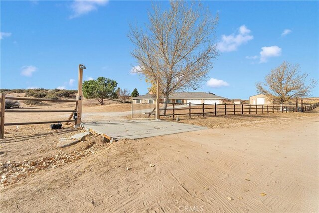 view of yard with a rural view