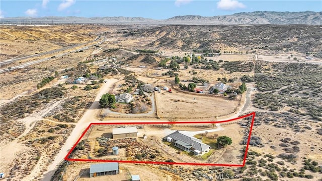 birds eye view of property featuring a desert view, a rural view, and a mountain view