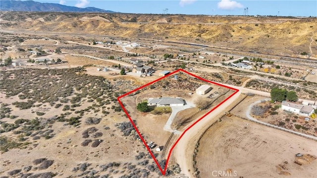 birds eye view of property with view of desert, a rural view, and a mountain view