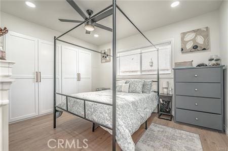 bedroom with ceiling fan and light wood-type flooring