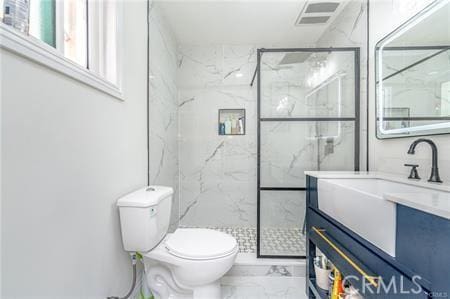 bathroom with an enclosed shower, vanity, and toilet