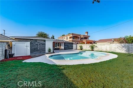 view of pool with a lawn