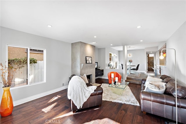 living room featuring recessed lighting, baseboards, and wood-type flooring