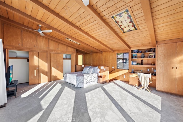 bedroom with wood ceiling, wood walls, lofted ceiling with beams, carpet flooring, and ceiling fan