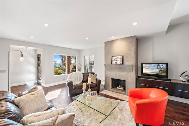 living room with a fireplace and dark hardwood / wood-style flooring