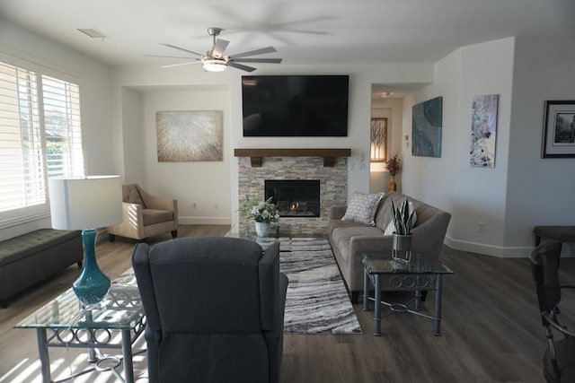 living room featuring ceiling fan, a fireplace, and hardwood / wood-style floors