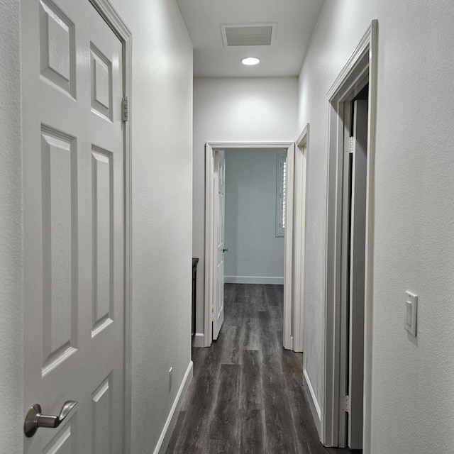 hall with dark hardwood / wood-style flooring