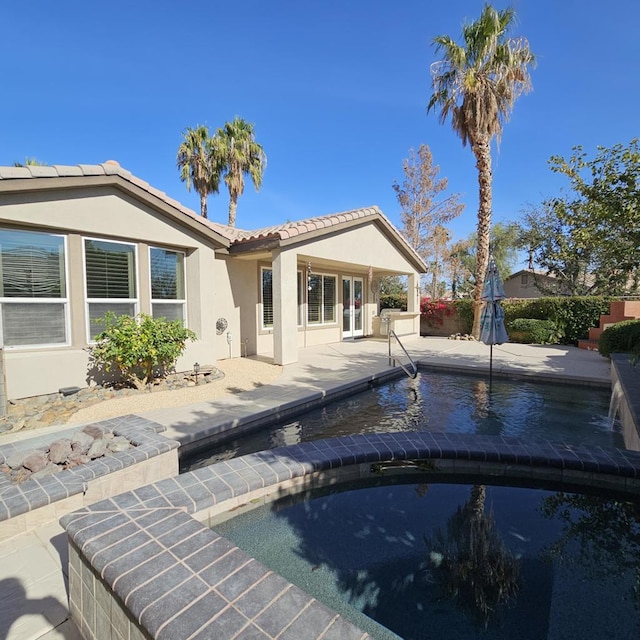 back of house featuring a patio area and french doors