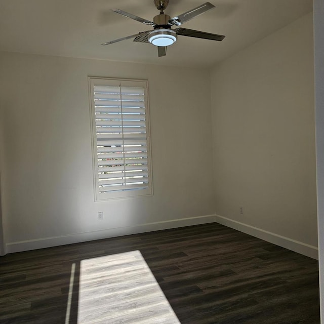 empty room featuring ceiling fan and dark hardwood / wood-style flooring