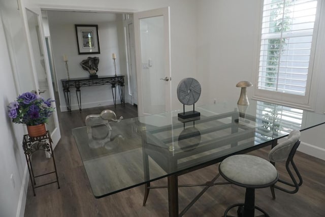 dining area with dark hardwood / wood-style flooring