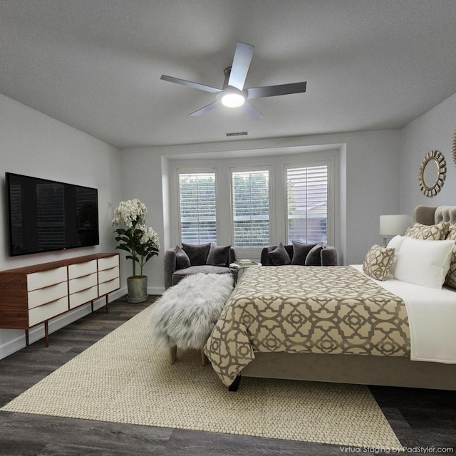 bedroom featuring ceiling fan and dark hardwood / wood-style flooring