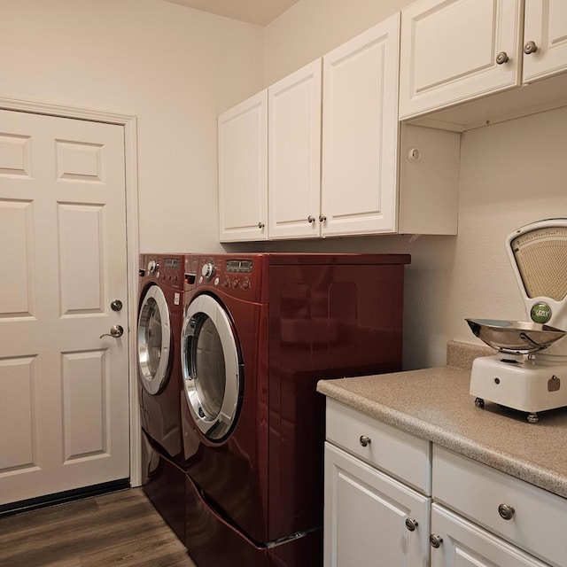 clothes washing area with cabinets, dark hardwood / wood-style floors, and independent washer and dryer