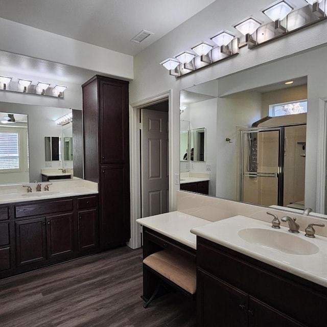 bathroom featuring a shower with shower door, wood-type flooring, and vanity