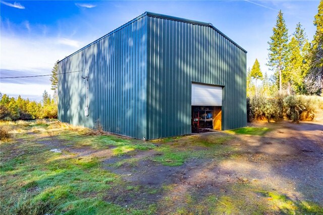 view of side of property featuring an outbuilding