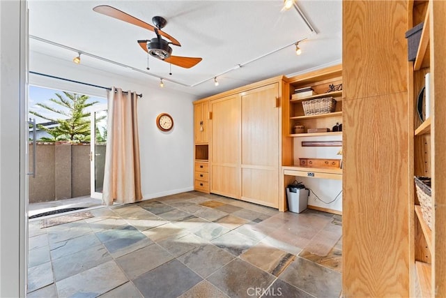 interior space with ceiling fan and rail lighting