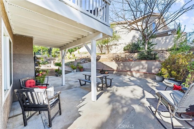 view of patio featuring outdoor lounge area and a balcony