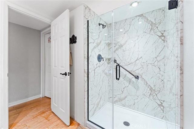 bathroom featuring walk in shower and hardwood / wood-style flooring