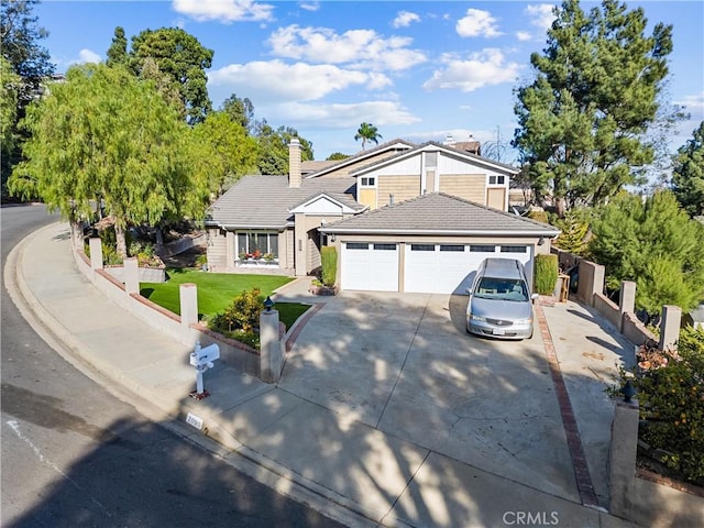 view of front of house featuring a front lawn and a garage