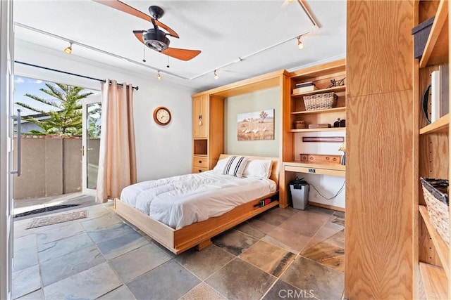 bedroom with ceiling fan and rail lighting