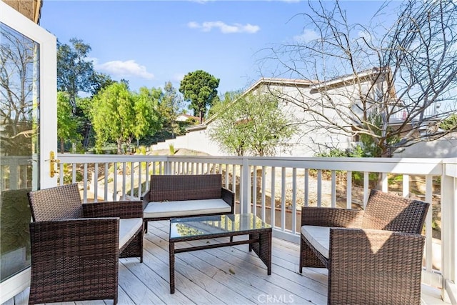 wooden terrace featuring an outdoor hangout area