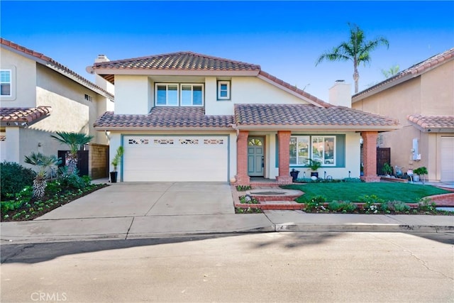 mediterranean / spanish home with a front lawn and a garage