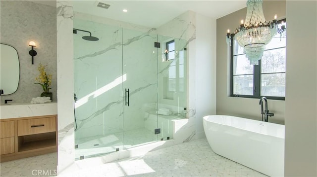 bathroom with separate shower and tub, vanity, and a notable chandelier