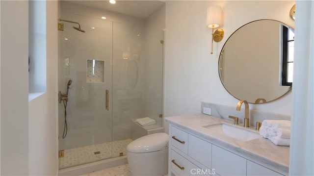 bathroom with a shower with shower door, vanity, and toilet