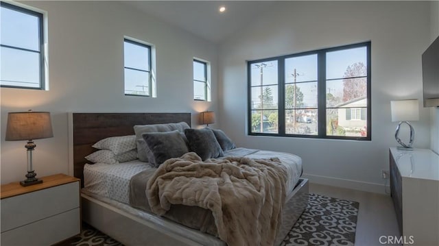 bedroom with vaulted ceiling and wood-type flooring