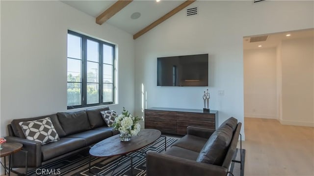 living room with high vaulted ceiling, beam ceiling, and light wood-type flooring