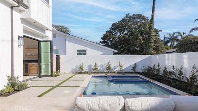 view of pool featuring an in ground hot tub and a patio