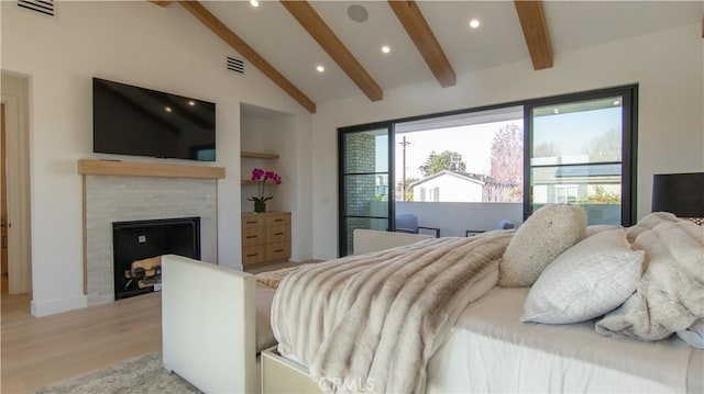 bedroom with light hardwood / wood-style flooring and lofted ceiling with beams