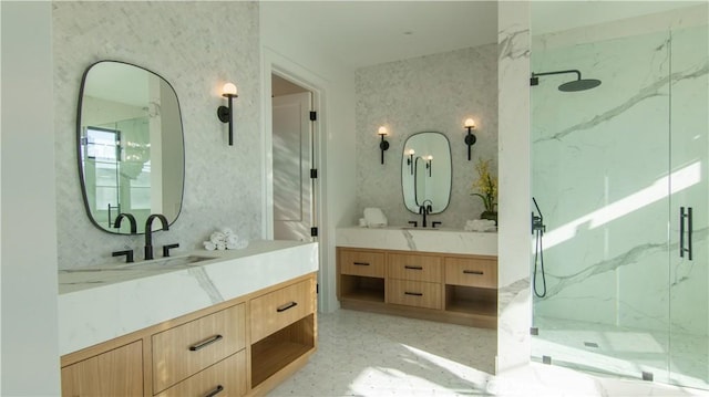 bathroom featuring a shower with door and vanity