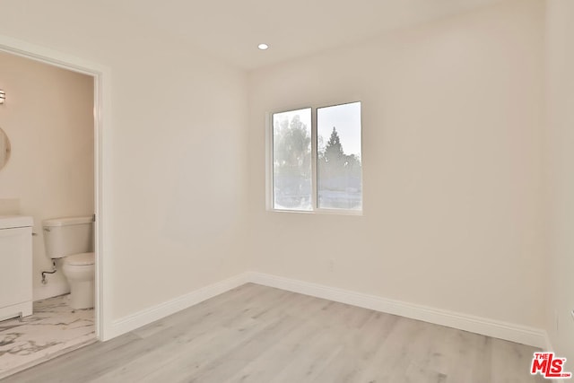 unfurnished room with light hardwood / wood-style floors