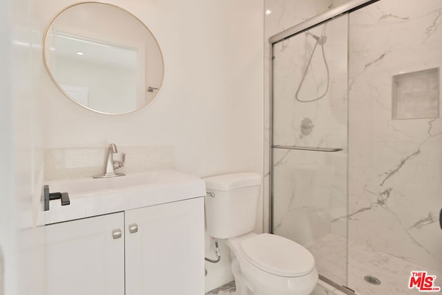 bathroom with walk in shower, vanity, and toilet