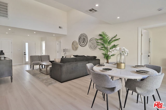 dining space with light hardwood / wood-style floors