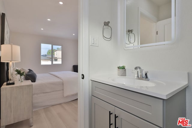 bathroom with hardwood / wood-style floors and vanity