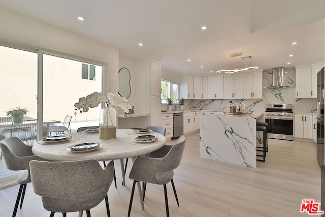 dining area with sink and light hardwood / wood-style flooring