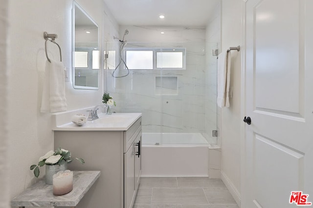 bathroom with bath / shower combo with glass door, tile patterned flooring, and vanity