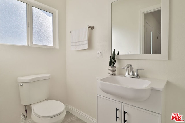 bathroom featuring toilet and vanity