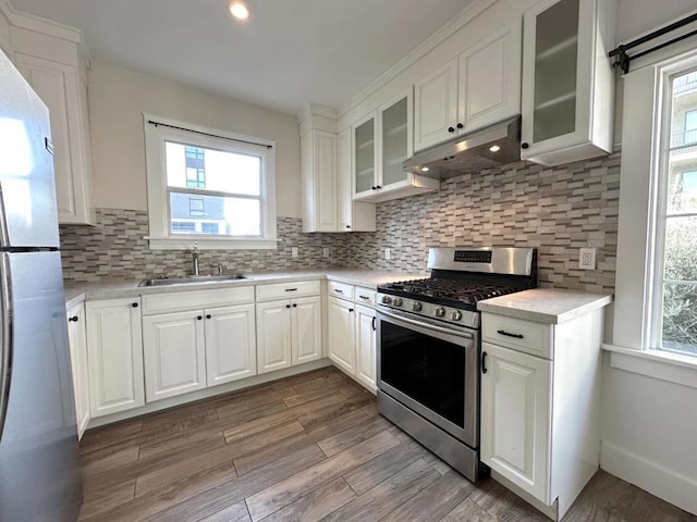 kitchen featuring a healthy amount of sunlight, sink, white cabinets, and appliances with stainless steel finishes