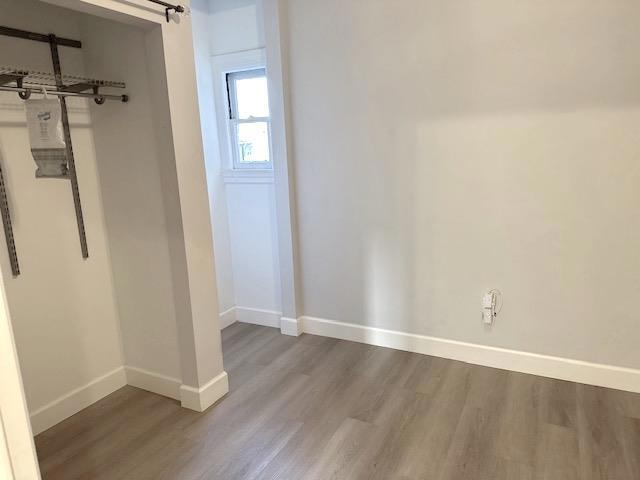 interior space featuring hardwood / wood-style floors and a barn door